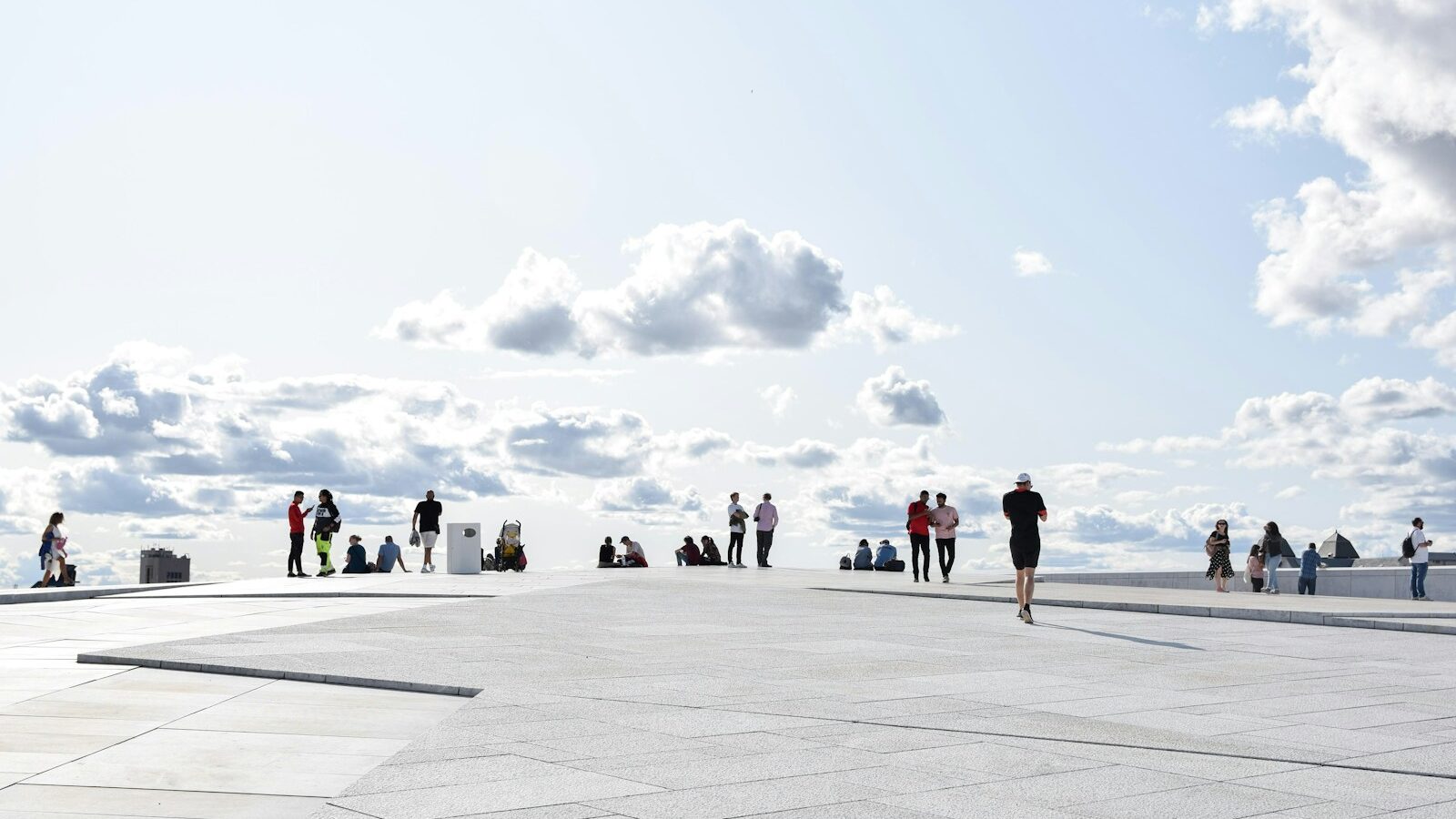 a group of people standing on top of a cement floor